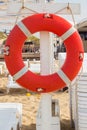 Hanging a red lifebuoy on a wooden pole for photos. Royalty Free Stock Photo