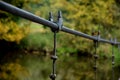 Hanging a rope on another rope. cable-stayed pedestrian bridge, footbridge over the river stream. fencing of the footbridge with m Royalty Free Stock Photo