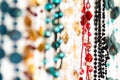 Hanging row of colourful beaded necklaces