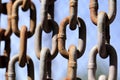 Hanging rusty chain on blue sky background