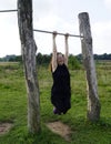 Hanging senior lady on fitness track Royalty Free Stock Photo