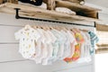 hanging shelf with newborn onesies and muslin swaddles Royalty Free Stock Photo