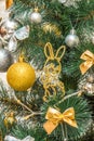 Hanging squirrel figure decoration on the Christmas tree. Gold and silver baubles, multi-colored bows, bells, lit garlands against Royalty Free Stock Photo