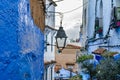 Hanging Streetlight in a Narrow Street in Chefchaouen Morocco with Blue Buildings Royalty Free Stock Photo