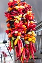 Hanging string of mixed colorful chili peppers for sale at Sineu market, Majorca
