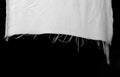 hanging teared rag spread isolated on black background , can use like a background or any texture. hole in the tissue. Unbleached