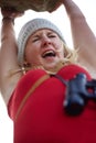 Hanging by a thread. A young climber hanging from a cliff and screaming in fear. Royalty Free Stock Photo