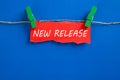 Hanging torn paper with new release word Royalty Free Stock Photo