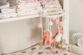 Hanging toys on the baby changing table