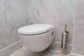 Hanging on wall white toilet bowl, grey natural marble Royalty Free Stock Photo