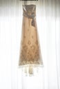 Hanging wedding dress or gown on the window Royalty Free Stock Photo