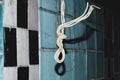 Hanging wire in front of an old wall in an old abandoned building. grunge background