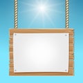 Hanging wooden blank sign board blue sky