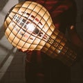 Hanging, wooden light shade lamp with bulb Royalty Free Stock Photo