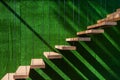 Hanging wooden stairs on artificial grass wall background Apartment staircase made of cables and wood apparently floating Royalty Free Stock Photo