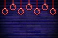 Hanging xmas or christmas balls glowing neon on brick wall copy space