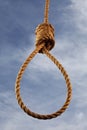 Hangman's noose with sky behind.