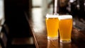 Hangouts with friends in pub and beer set. Two glasses of light beer with foam on wooden bar counter in daylight in