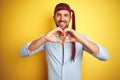 Hangover business man drunk and crazy for hangover wearing tie on head smiling in love showing heart symbol and shape with hands Royalty Free Stock Photo