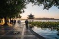 Hangzhou, China - November 9 2019: Beautiful day by the West Lake, people walking by the lake