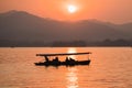 Hangzhou, China - November 9 2019: Beautiful sunset by the West Lake, a boat sailing on the lake Royalty Free Stock Photo