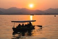 Hangzhou, China - November 9 2019: Beautiful sunset by the West Lake, a boat sailing on the lake Royalty Free Stock Photo