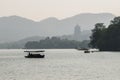 Hangzhou, China - November 9 2019: Beautiful day by the West Lake, a boat sailing on the lake Royalty Free Stock Photo