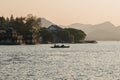 Hangzhou, China - November 9 2019: Beautiful sunset by the West Lake, boats sailing on the lake Royalty Free Stock Photo