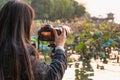 Hangzhou, China - November 9 2019: Girl photographer taking a picture with a big camera to a sunset by the West Lake Royalty Free Stock Photo