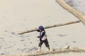 Hani woman working in a rice paddy in YuanYang.