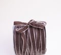 A hank of brown velvet ribbon with bow
