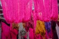 Hanks of hanging wool drying, freshly dyed red Royalty Free Stock Photo