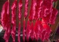 Hanks of hanging wool drying, freshly dyed red Royalty Free Stock Photo