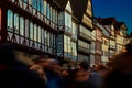Half-timbered facades over a crowd of people in the evening sun in the old town of Hannover