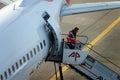 Ground staff conducting a patrol at the rear of the aircraft using a mobile staircase