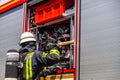 German fireman takes an object from a fire engine