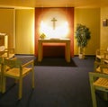 View of the Christian chapel in the airport with wooden chairs and a simple altar for prayer and reading the Bible