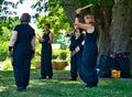 A group of women in black clothes is waiting for the beginning of the Taiko drum performance at the German-Japanese festival