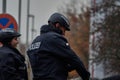 German policewoman and policeman with riding helmets and black uniform riding on the back of police horses Royalty Free Stock Photo