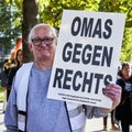 Poster with the inscription Omas gegen rechts in the hand of a pensioner at a demonstration of the trade union Verdi Royalty Free Stock Photo