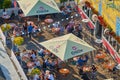 Visitors of a summer party in Germany enjoy the sunny day with coffee and beer in an outdoor cafe, picture from above