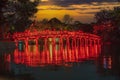 Hanoi Red Bridge at night. The wooden red-painted bridge over the Hoan Kiem Lake connects the shore and the Jade Island