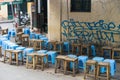 Hanoi, Vietnam - Apr 5, 2015: Lines of seats waiting for people in a coffee street stall in Luong Ngoc Quyen street. Drinking on s Royalty Free Stock Photo