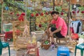 Hanoi, Vietnam - Apr 5, 2015: A sale man repairs cage in bird stall in Nguyen Khoai street, Hanoi Royalty Free Stock Photo