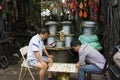 Hanoi, Vietnam - Apr 20, 2014: Unidentified men play chess in front of a tooling store on Hanoi street, Vietnam