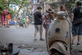Parked beige vespa scooter and street life, Hanoi, Vietnam