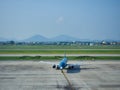 HANOI, VIETNAM - August 7, 2019 : Vietnam Airlines aircraft prepares for docking with landing sleeve and loading air cargo Royalty Free Stock Photo