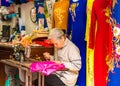 HANOI, VIETNAM - DECEMBER 16, 2016: Seamstress sews dresses on the local market.