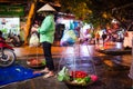 An unidentified traditional seller beside the street