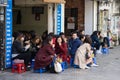 Hanoi, Vietnam - Feb 28, 2016: People drink coffee, tea or juice fruit on cafe stall on sidewalk in Nha Tho street, center of Hano